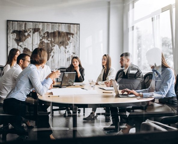 Group Of People Working Out Business Plan In An Office